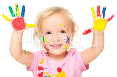 Portrait of a cute little girl playing with paints