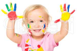 Portrait of a cute little girl playing with paints