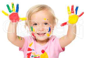 Portrait of a cute little girl playing with paints