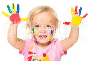 Portrait of a cute little girl playing with paints