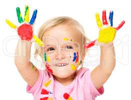 Portrait of a cute little girl playing with paints