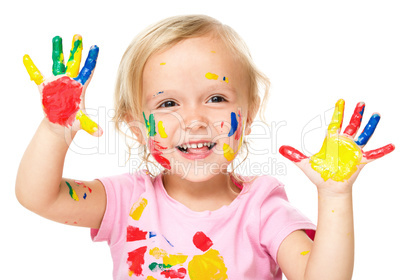 Portrait of a cute little girl playing with paints