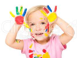 Portrait of a cute little girl playing with paints