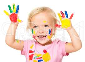 Portrait of a cute little girl playing with paints