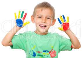 Portrait of a cute boy playing with paints