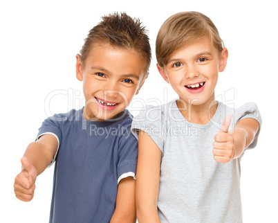 Little boy and girl are showing thumb up sign