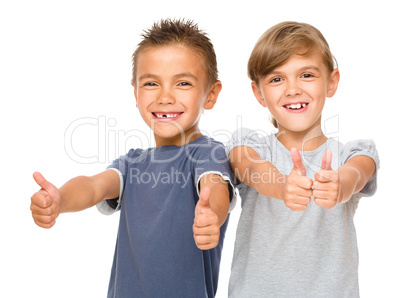 Little boy and girl are showing thumb up sign