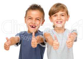 Little boy and girl are showing thumb up sign