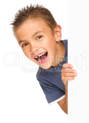 Little boy is looking out from the blank banner