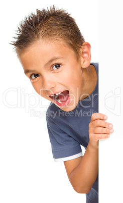 Little boy is looking out from the blank banner