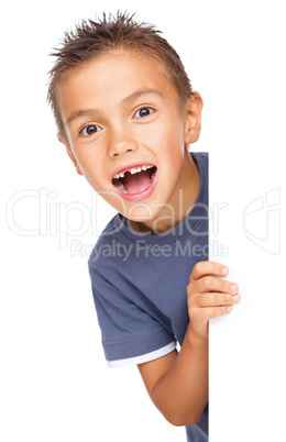 Little boy is looking out from the blank banner