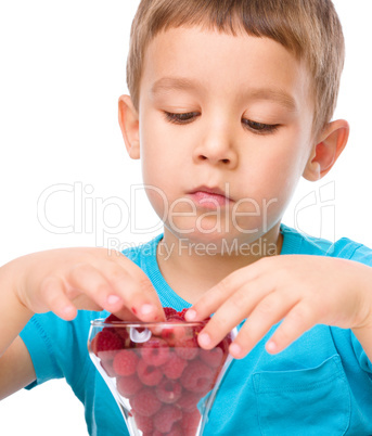 Little boy with raspberries