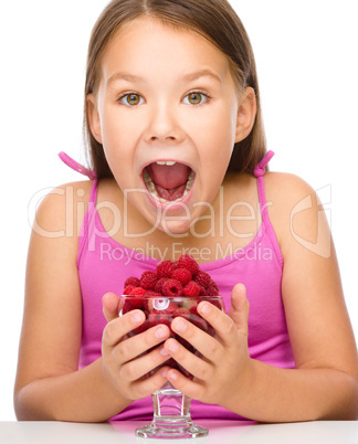 Little girl with raspberries