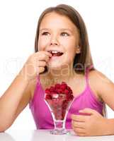 Little girl with raspberries