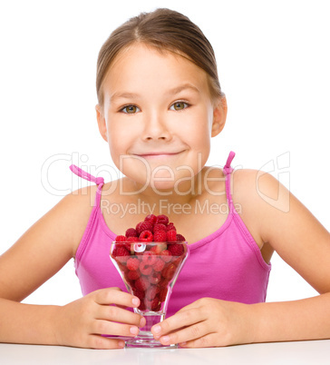 Little girl with raspberries