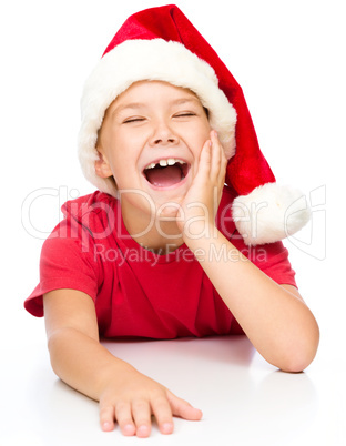 Little girl in santa hat is laughing