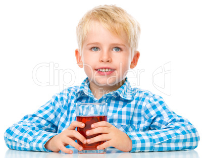 Little boy with glass of cherry juice