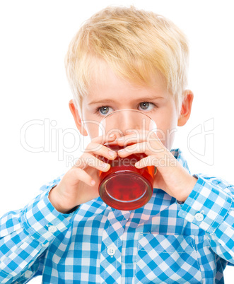 Little boy with glass of cherry juice