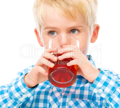 Little boy with glass of cherry juice