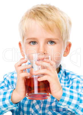 Little boy with glass of cherry juice