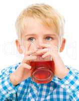 Little boy with glass of cherry juice