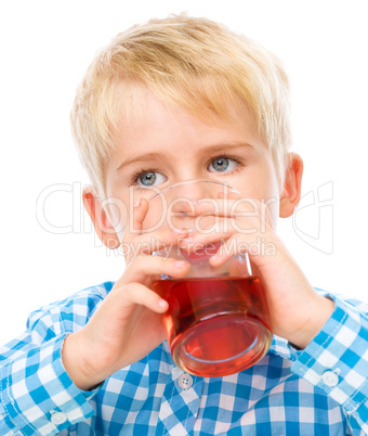 Little boy with glass of cherry juice