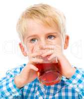 Little boy with glass of cherry juice