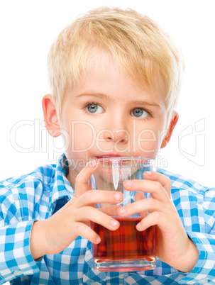 Little boy with glass of cherry juice