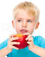 Portrait of a cute little boy with red apple