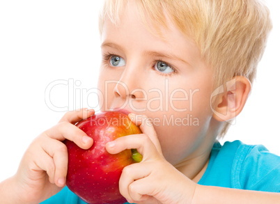 Portrait of a cute little boy with red apple