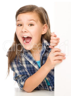 Little girl is looking from out blank board