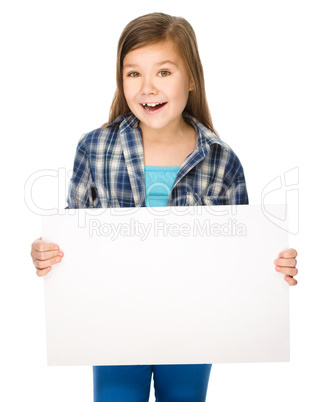 Little girl is holding a blank banner