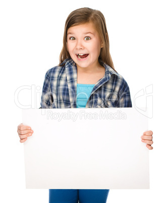 Little girl is holding a blank banner