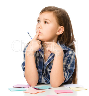 Girl is writing on color stickers using pen