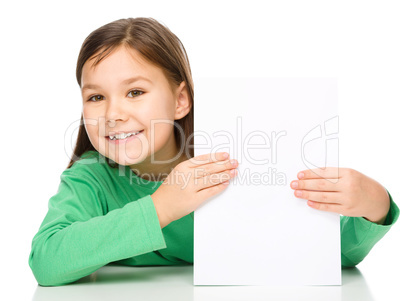 Little girl is looking from out blank board