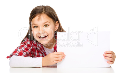 Little girl is looking from out blank board