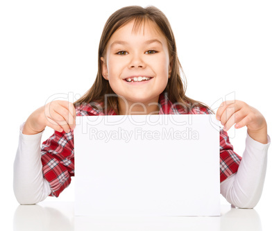 Little girl is looking from out blank board