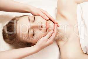 Spa. Woman enjoying anti-aging facial massage