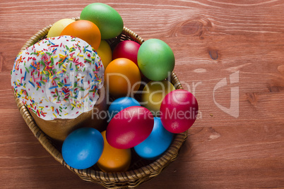 Easter eggs of different colors and cake