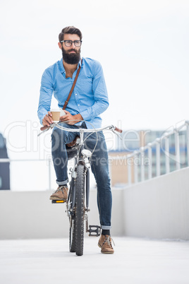 Hipster posing on his bike