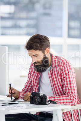 Hipster man writing on his desk