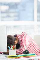 Hipster man sitting at computer desk is tired