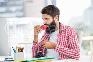 Hipster man is drinking a coffee