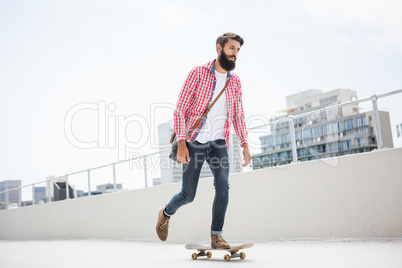 Hipster man doing skateboard