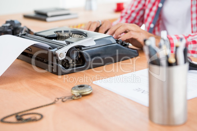 Hipster man using a typewriter