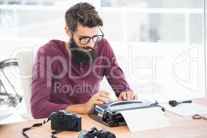 Hipster man using a typewriter
