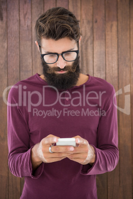 Hipster man sending a message with his smartphone Hipster man sending a message with his smartphone