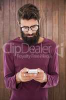 Hipster man sending a message with his smartphone