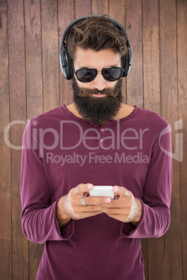 Hipster man sending a message with his smartphone