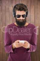 Hipster man sending a message with his smartphone